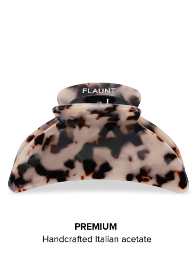 Blonde tortoise shell claw clip with black speckled pattern and black curved clasp.