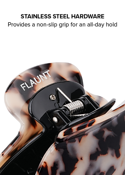 Blonde tortoise shell claw clip with black stainless steel hardware and grip mechanism.
