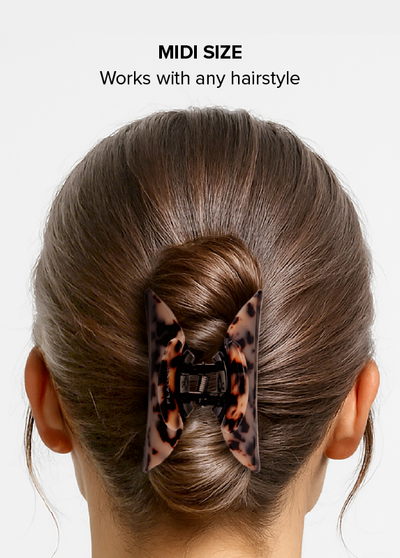 Blonde tortoise shell claw clip in midi size holding hair in low ponytail, back view.