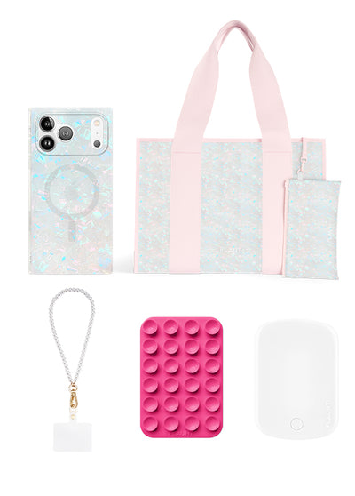 Five-piece bundle set including iridescent tote bag with pink handles, matching phone case, wristlet, pink pop-it fidget toy,