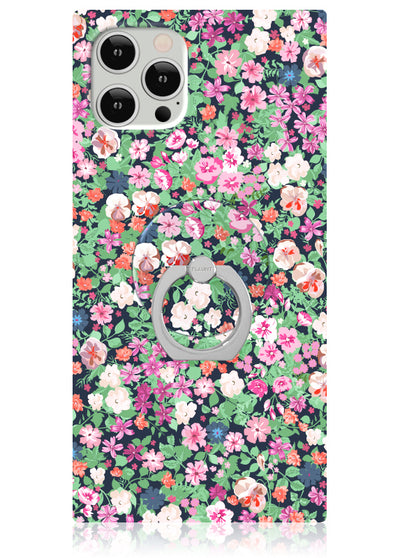 Square phone case with multicolored floral pattern and circular metal ring stand attachment.