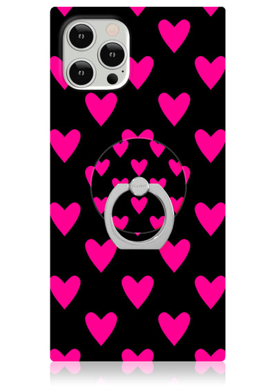 Silver metal ring stand with heart-shaped grip attached to black phone case with bright pink heart pattern.