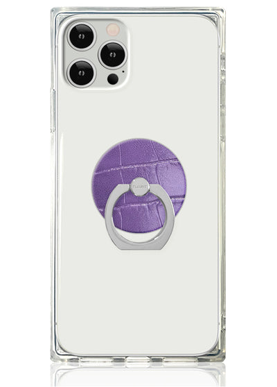 Clear phone case with purple crocodile-textured circular ring stand and silver metal grip attached to back.