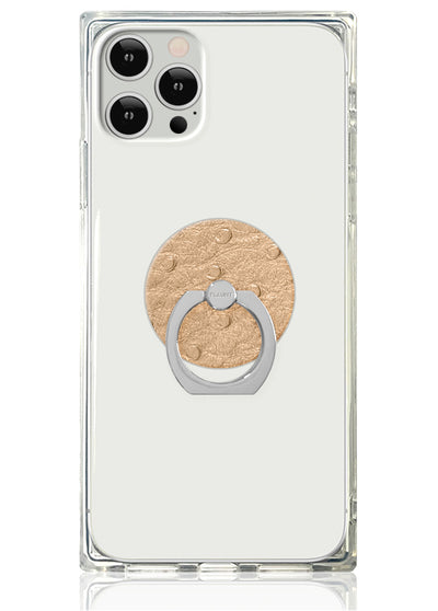 Clear phone case with tan textured circular backing and silver metal ring stand attached to center.