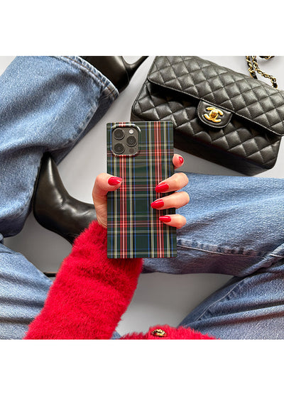 Green and red plaid iPhone case with camera cutout, held in hand with red nail polish.