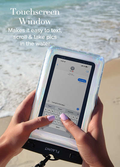 Holographic waterproof phone pouch with clear touchscreen window held in hands at beach.
