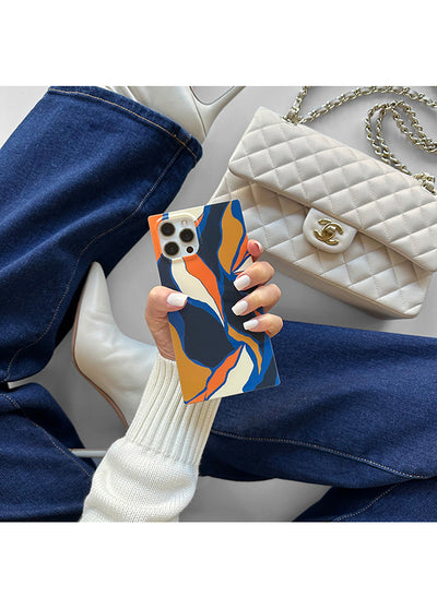 Navy, orange, and cream abstract floral patterned iPhone case with square shape held in hand.