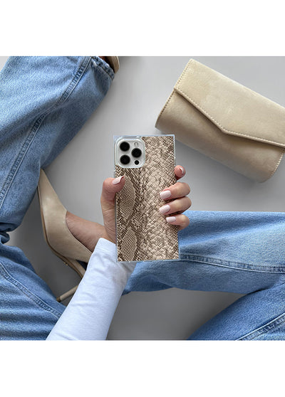 Beige iPhone case with python texture pattern held in hand, styled with denim and nude accessories.