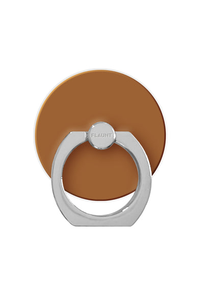 Caramel-colored circular phone ring stand with silver metal attachment loop and center grip knob.