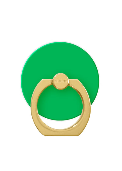 Emerald green circular phone ring stand with gold metal grip and rotating top knob labeled "FLAUNT."