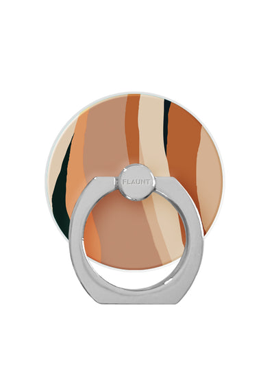 Circular phone ring stand with neutral abstract print in orange, tan, and black stripes, silver metal grip and ball joint.
