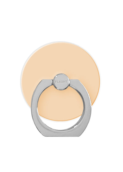 Nude almond circular adhesive ring stand with silver metal base and rotating grip for phone attachment.