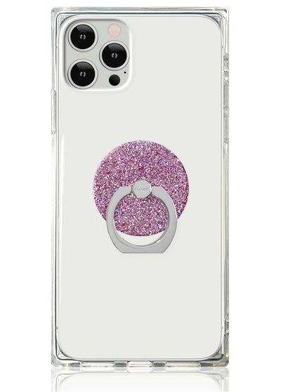 Clear phone case with pink glitter circular ring stand and metal holder on back.