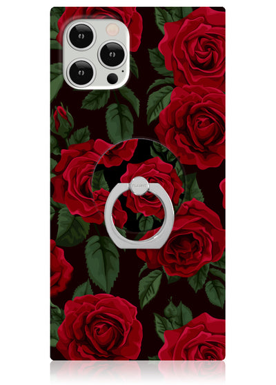 White phone ring stand attached to phone case with red rose and green leaf print on black background.