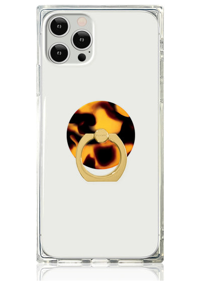 Clear phone case with tortoise shell patterned ring stand in gold metal and amber acetate.