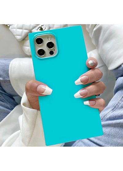 Turquoise square iPhone case with metallic camera ring, held in hand showing flat rectangular shape.