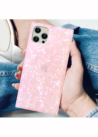 Pink pearl textured square iPhone case with white speckled pattern, held in hand showing camera cutout.