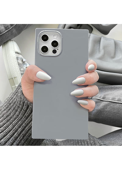 Gray square iPhone case with camera cutout, held in hand showing smooth matte finish.