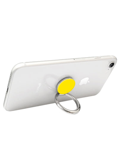White phone with yellow circular adhesive ring stand attached to back, metal loop extends from ring for gripping.