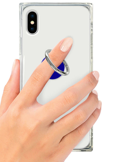 Cobalt blue ring stand attached to clear phone case, held in hand against smartphone.