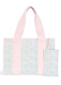 ["Pink", "tote", "bag", "with", "floral", "patterned", "panels", "and", "two", "matching", "smaller", "pouches", "included", "in", "set."]